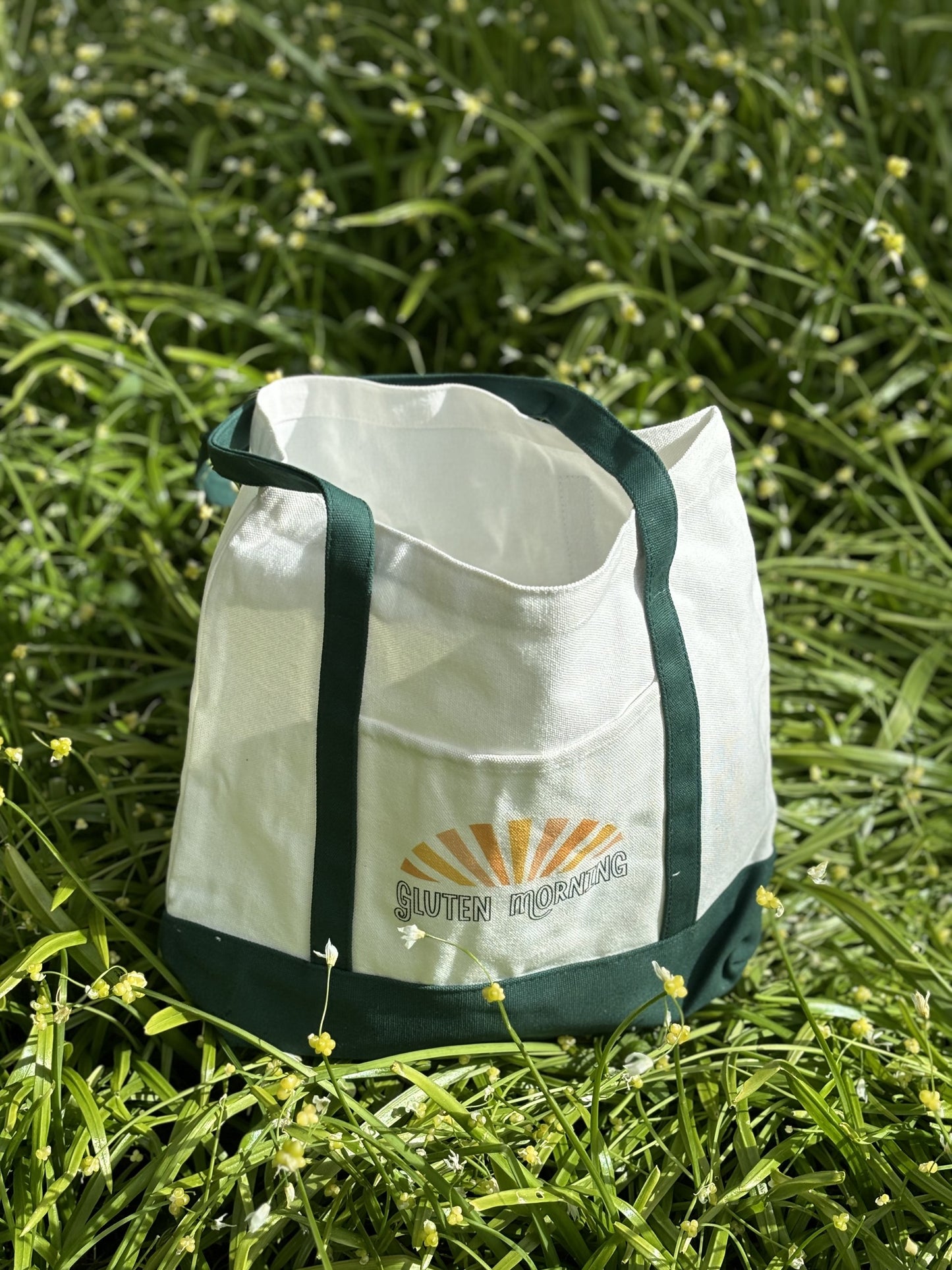 Green canvas tote bag with front pocket