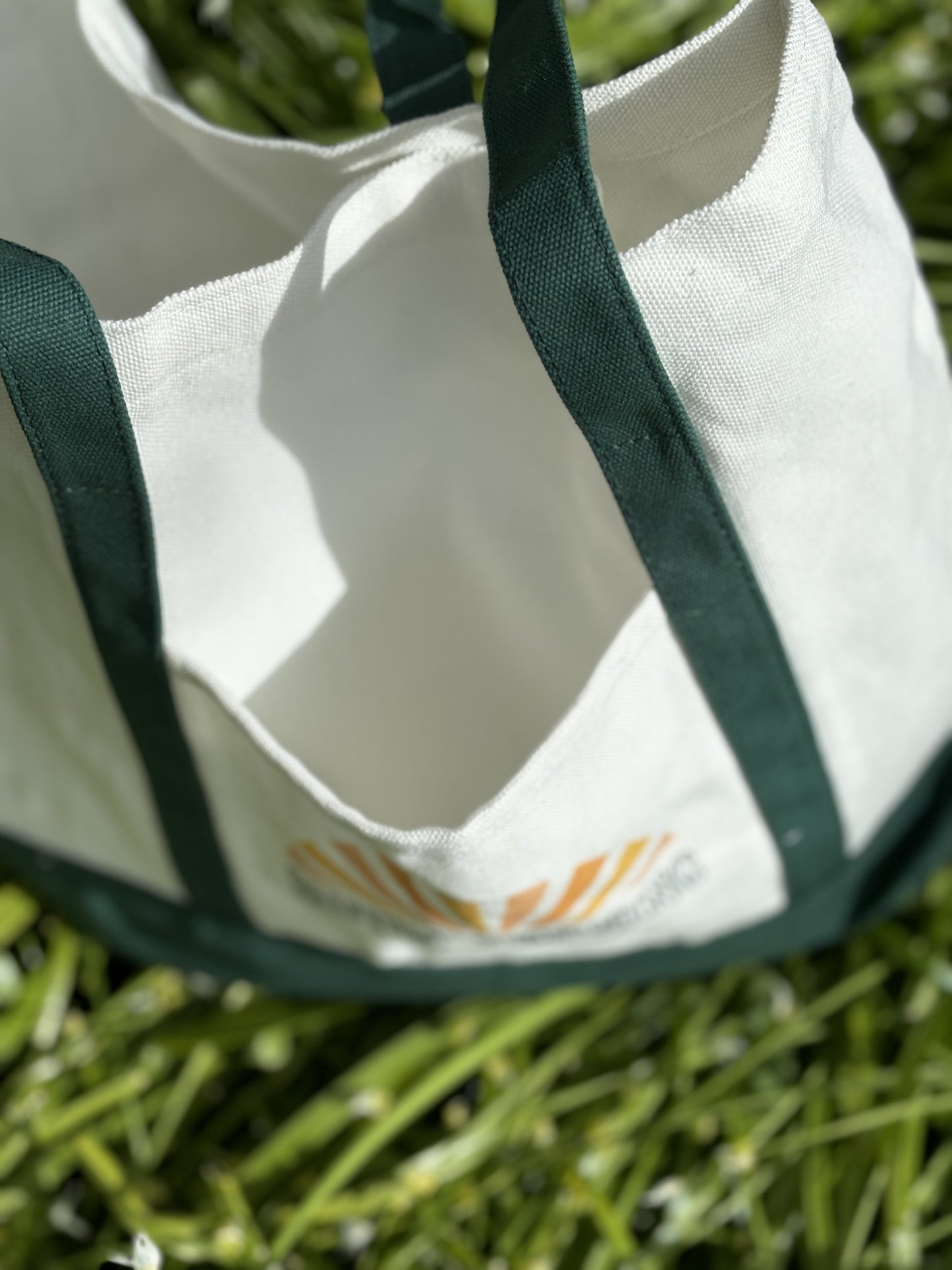 Green canvas tote bag with front pocket